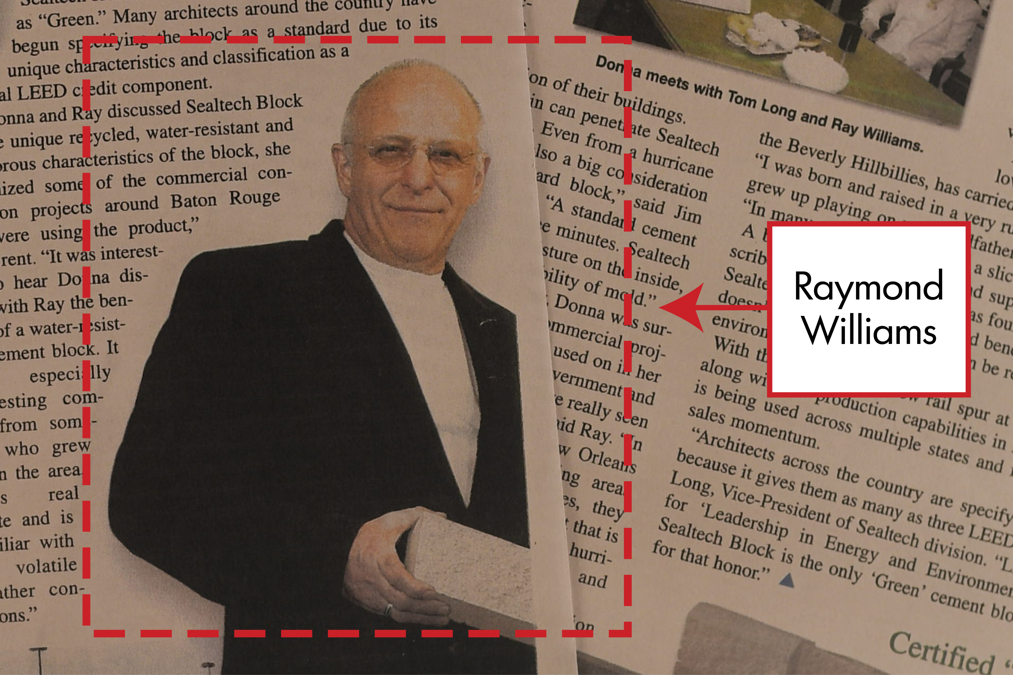 A photo of Raymond Williams appearing in an article holding a brick.